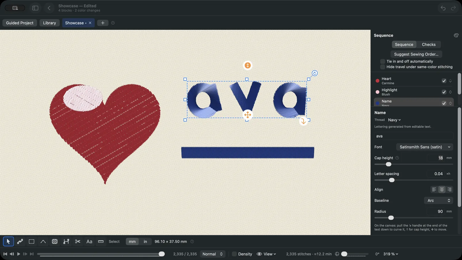 Satin lettering spelling Ava on an arc beside an embroidered heart